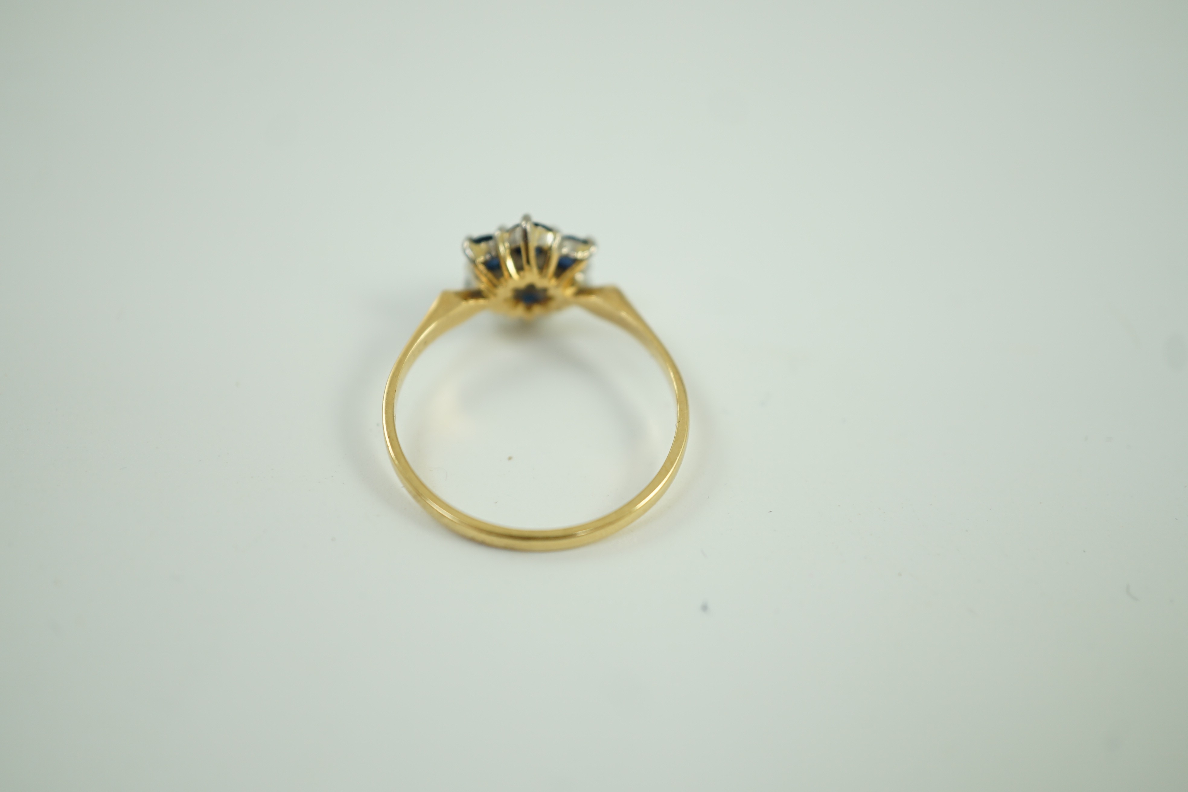 A modern 18ct gold, sapphire and diamond cluster set ring, size Q, gross weight 2.9 grams.